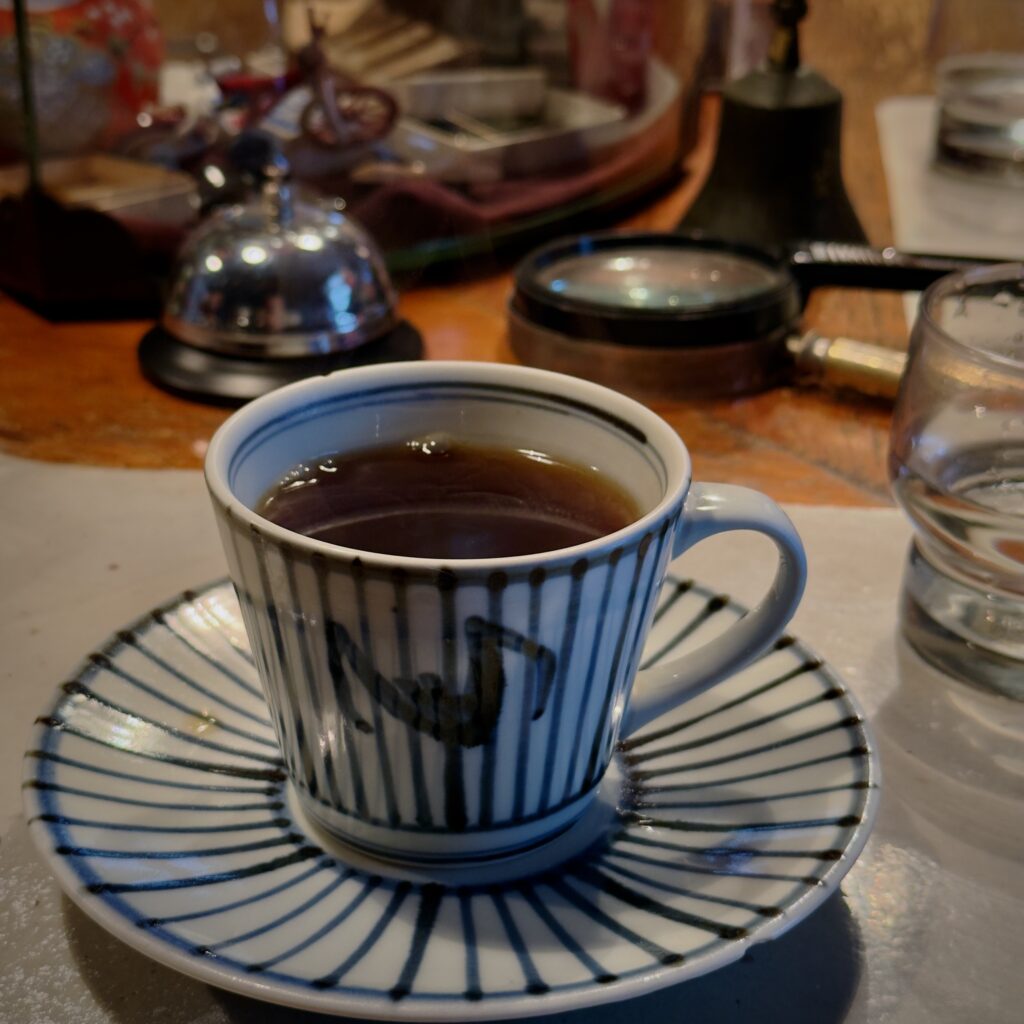 Retro interior of Kaikodo Coffee Kanazawa, a traditional kissaten near Oyama Shrine with antique coffee mill