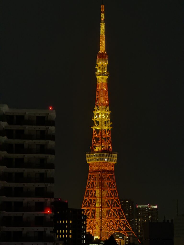 Rooftop view of Tokyo Tower illuminated at night from Tokyo Confidential bar in Azabu-Juban, Tokyo